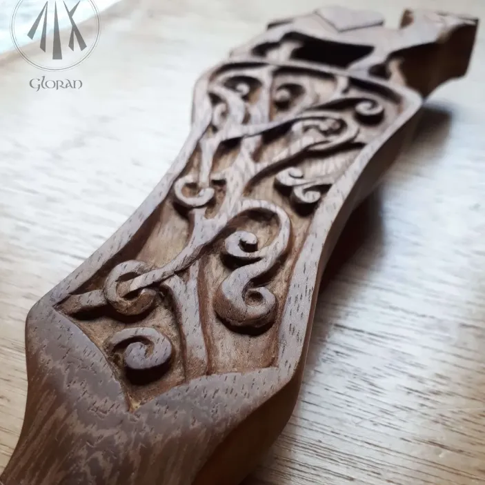 A lovespoon with a middle eastern themed design in black walnut